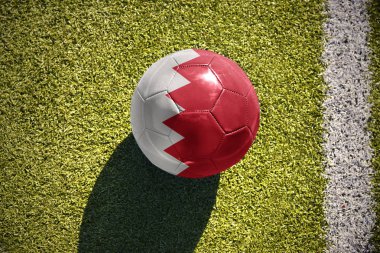 sahada futbol topu Bahreyn bayrağı ile yatıyor