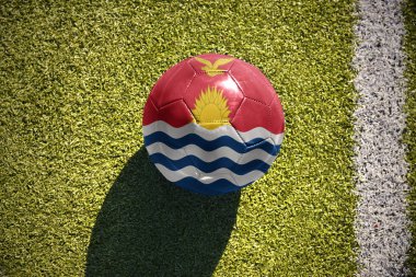 football ball with the national flag of Kiribati lies on the field clipart
