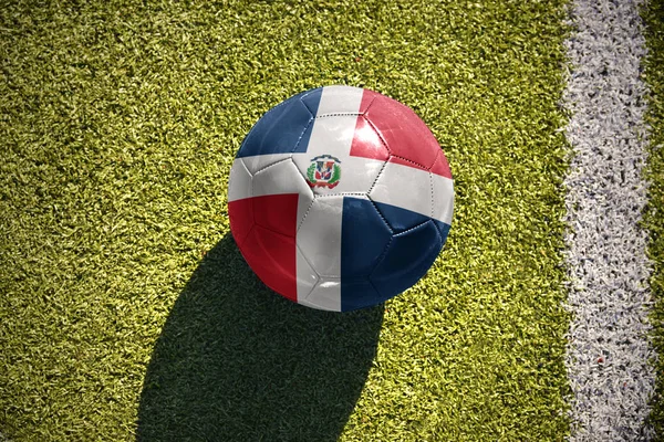 Football ball with the national flag of dominican republic lies on the field — Stock Photo, Image
