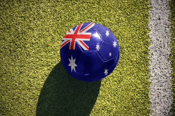 Football ball with the national flag of australia lies on the field — Stock Photo, Image