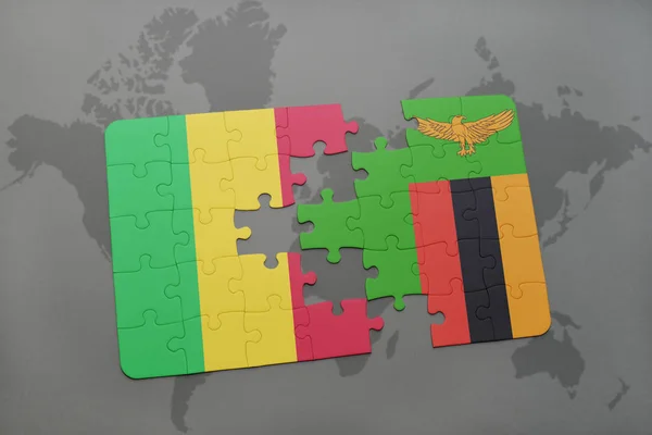 Puzzle con la bandiera nazionale di mali e zambia su una mappa del mondo — Foto Stock