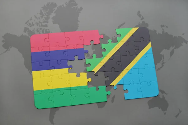 Puzzel met de nationale vlag van mauritius en tanzania op een wereldkaart — Stockfoto