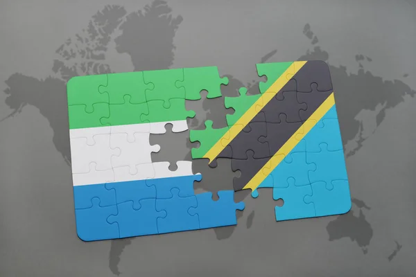 Puzzle with the national flag of sierra leone and tanzania on a world map — Stock Photo, Image