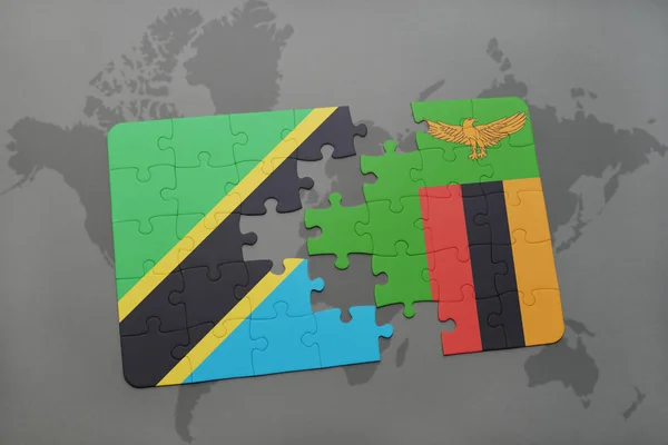 Puzzel met de nationale vlag van tanzania en zambia op een wereldkaart — Stockfoto