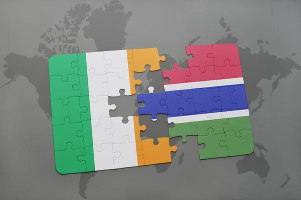Puzzle with the national flag of ireland and gambia on a world map — Stock Photo, Image