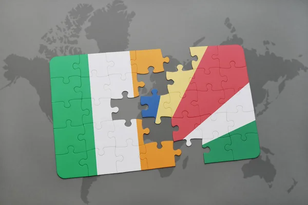 Puzzle with the national flag of ireland and seychelles on a world map — Stock Photo, Image