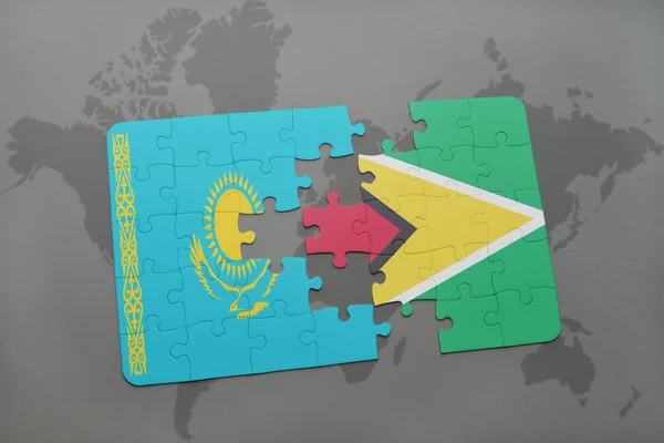 Puzzle with the national flag of kazakhstan and guyana on a world map — Stock Photo, Image