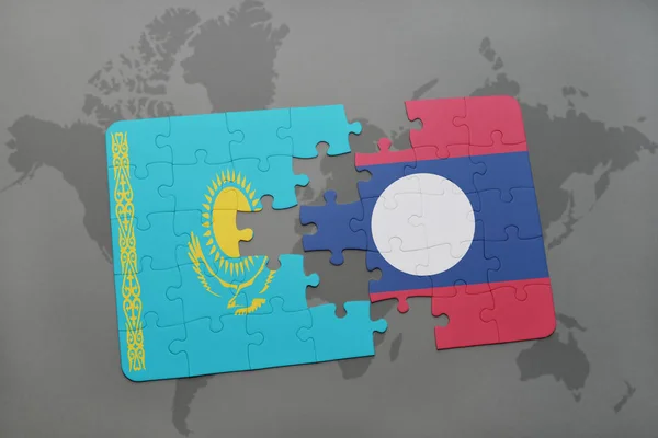 Puzzle with the national flag of kazakhstan and laos on a world map — Stock Photo, Image