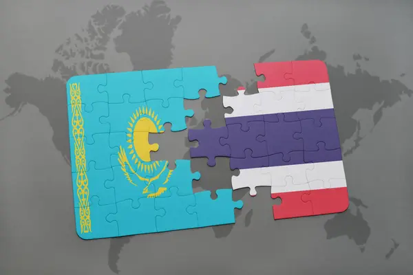 Rompecabezas con la bandera nacional de Kazajstán y Tailandia en un mapa del mundo — Foto de Stock