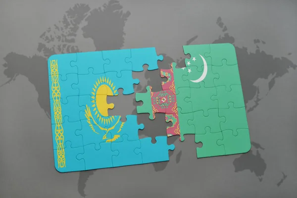 Pussel med Kazakstan och turkmenistan flagga på en världskarta — Stockfoto