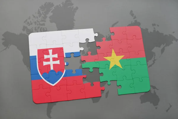 Puzzle with the national flag of slovakia and burkina faso on a world map — Stock Photo, Image