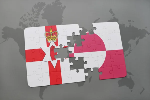 Puzzle with the national flag of northern ireland and greenland on a world map — Stock Photo, Image