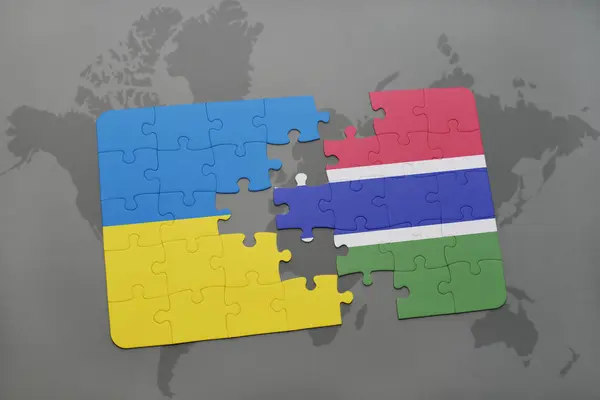 Головоломка з національним прапором України та Гамбії на карті світу — стокове фото