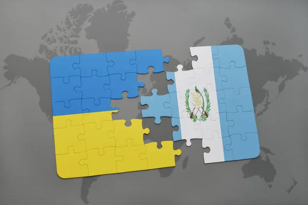 Puslespil med det nationale flag ukraine og guatemala på et verdenskort - Stock-foto