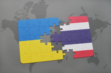 Ukrayna ve Tayland ulusal bayrak bir dünya haritası üzerinde ile bulmaca
