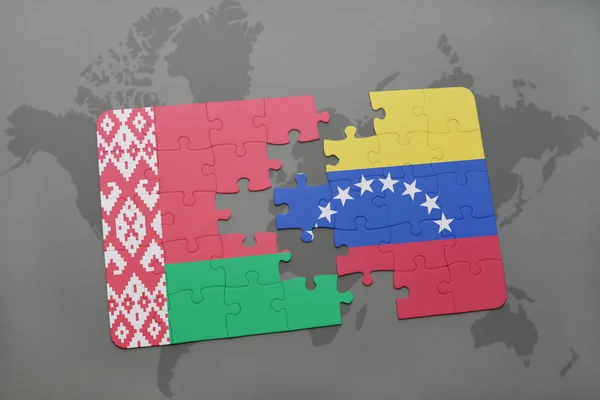 Puzzle mit der Nationalflagge von Weißrussland und Venezuela auf einer Weltkarte — Stockfoto