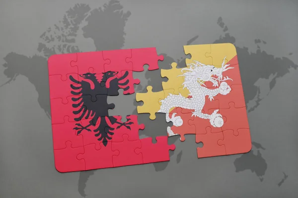 Puzzel met de nationale vlag van Albanië en bhutan op een wereldkaart — Stockfoto