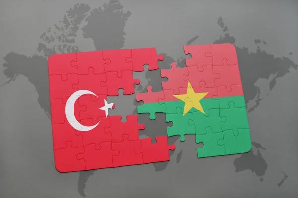 Puzzel met de nationale vlag van Turkije en burkina faso op een kaart van de wereld — Stockfoto