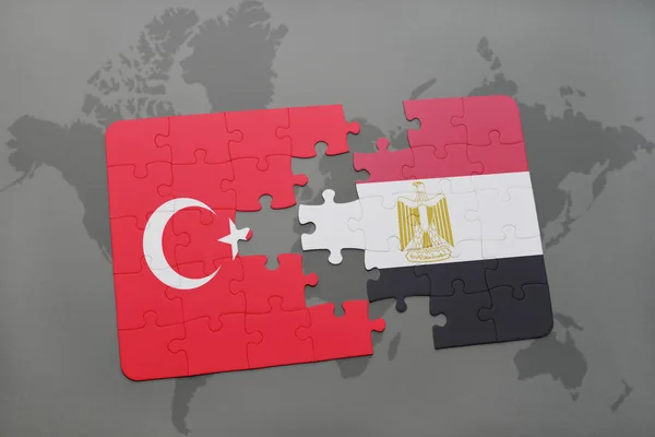 Puzzel met de nationale vlag van Turkije en Egypte op een kaart van de wereld — Stockfoto