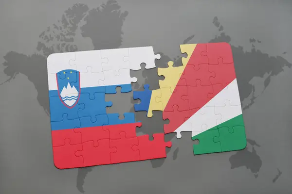 Puzzle with the national flag of slovenia and seychelles on a world map — Stock Photo, Image