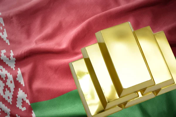 Luminosi lingotti d'oro sulla bandiera di Bielorussia — Foto Stock