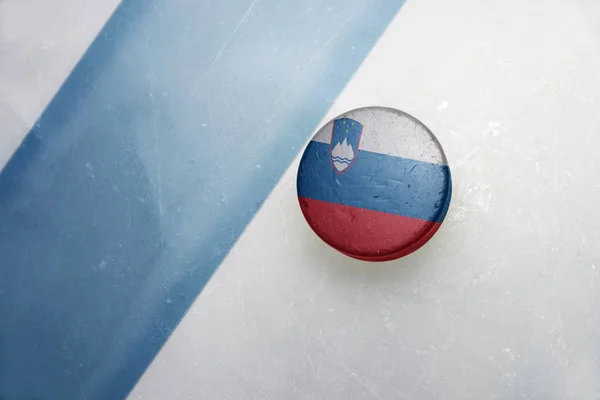 Old hockey puck with the national flag of slovenia. — Stock Photo, Image