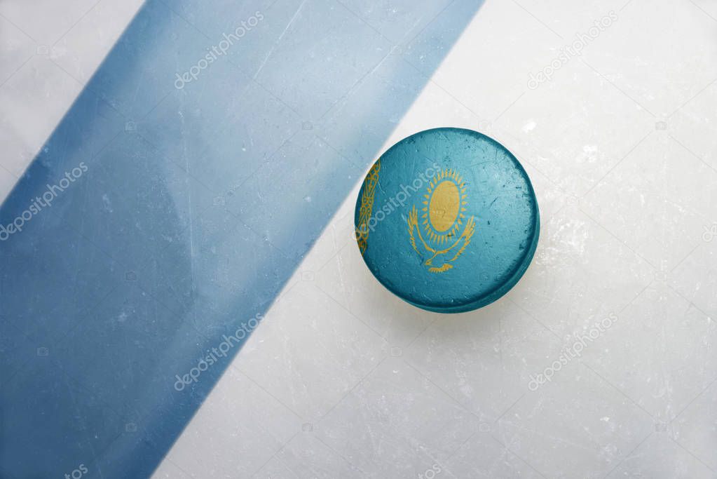 old hockey puck with the national flag of kazakhstan.