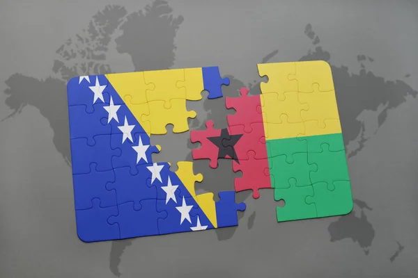 Puzzle avec le drapeau national de la bosnia et l'herzénie et la Guinée-Bissau sur une carte du monde — Photo