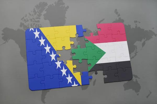 Quebra-cabeça com a bandeira nacional da Bósnia e Herzegovina e sudan em um mapa do mundo — Fotografia de Stock