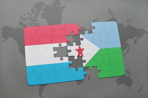 Puzzel met de nationale vlag van Luxemburg en djibouti op een wereldkaart — Stockfoto