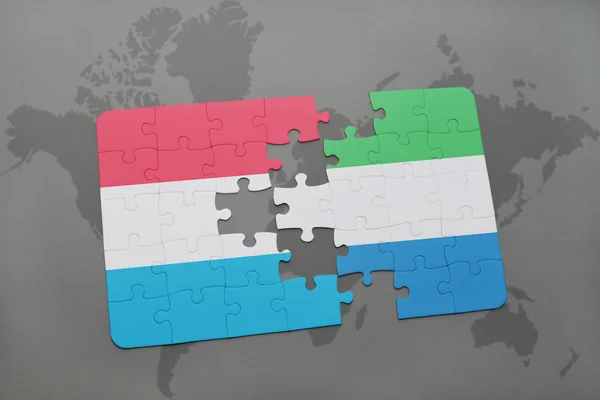 A nemzeti zászló, a luxemburgi és a sierra Leone-i, a világtérképen puzzle — Stock Fotó