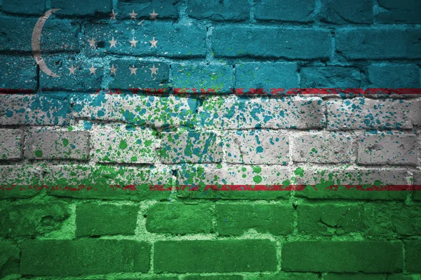 Üzbegisztán zászlaja a tégla falon festett — Stock Fotó