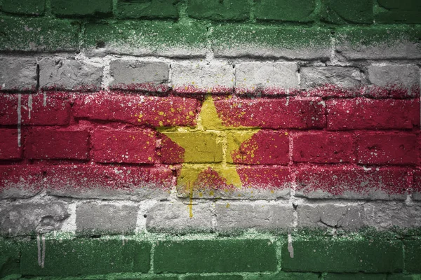 Painted national flag of suriname on a brick wall — Stock Photo, Image