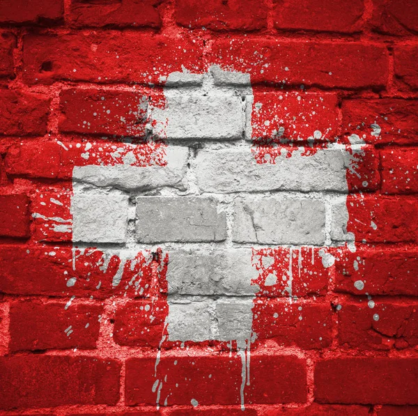 Painted national flag of switzerland on a brick wall — Stock Photo, Image