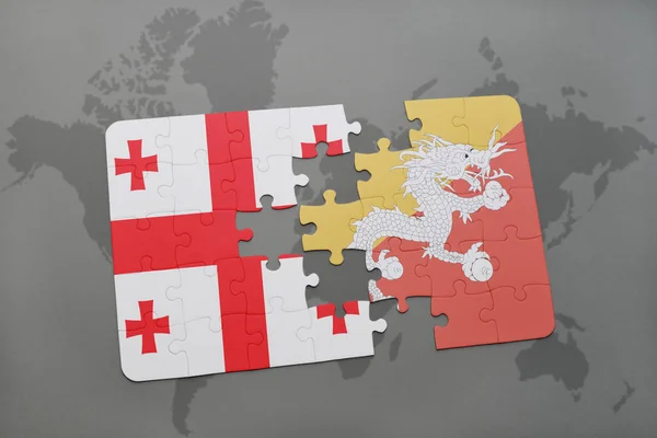 Puzzel met de nationale vlag van Georgië en bhutan op een wereldkaart — Stockfoto