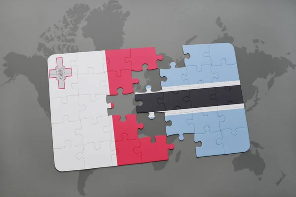 Puzzle con la bandiera nazionale di Malta e Botswana su una mappa del mondo — Foto Stock