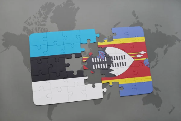 Puzzle avec le drapeau national de l'Estonie et du Swaziland sur une carte du monde — Photo