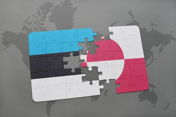 Puzzle with the national flag of estonia and greenland on a world map — Stock Photo, Image