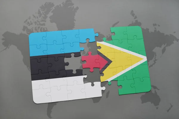 Puzzle with the national flag of estonia and guyana on a world map — Stock Photo, Image