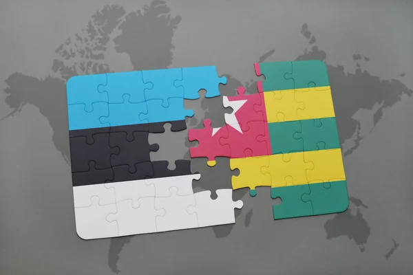 Puzzle with the national flag of estonia and togo on a world map — Stock Photo, Image