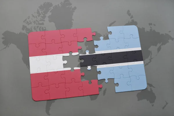 Головоломка з національним прапором Латвії і ботсвана на карті світу — стокове фото