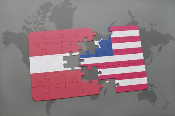 Puzzle with the national flag of latvia and liberia on a world map — Stock Photo, Image