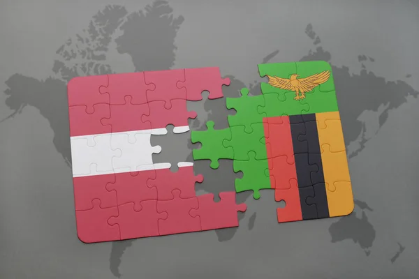 Puzzel met de nationale vlag van Letland en zambia op een wereldkaart — Stockfoto