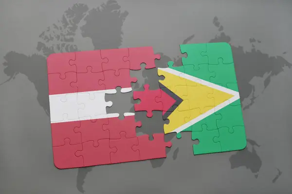 Головоломка з національним прапором Латвії і Хуани на карті світу — стокове фото