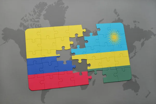 Quebra-cabeça com a bandeira nacional da colômbia e Ruanda em um mapa do mundo — Fotografia de Stock