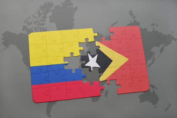 Quebra-cabeça com a bandeira nacional da colômbia e timor leste em um mapa do mundo — Fotografia de Stock