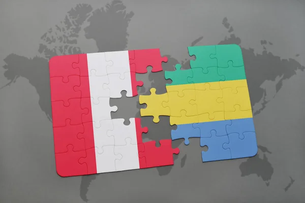 Puzzle with the national flag of peru and gabon on a world map — Stock Photo, Image