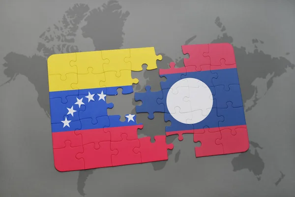Puzzle with the national flag of venezuela and laos on a world map — Stock Photo, Image