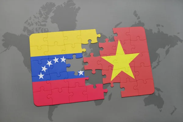 Puzzle with the national flag of venezuela and vietnam on a world map — Stock Photo, Image