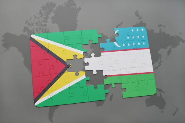 A nemzeti zászló, guyana és Üzbegisztán a világtérképen puzzle — Stock Fotó